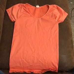 Coral colored t shirt.